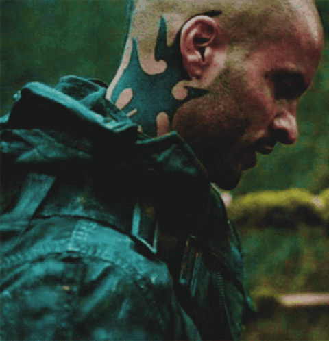 A Man With A Tattoo On His Neck Is Wearing A Jacket GIF