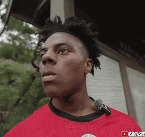 a man with a tattoo on his neck is wearing a red shirt that says all american on it