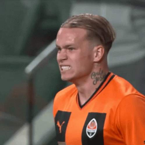 A Man With A Tattoo On His Neck Is Wearing An Orange Shirt With The Letter Y On It GIF