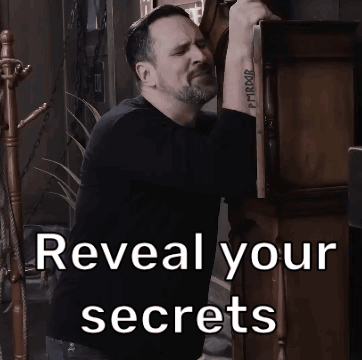 A Man With A Tattoo On His Wrist Is Standing Next To A Sign That Says Reveal Your Secrets GIF
