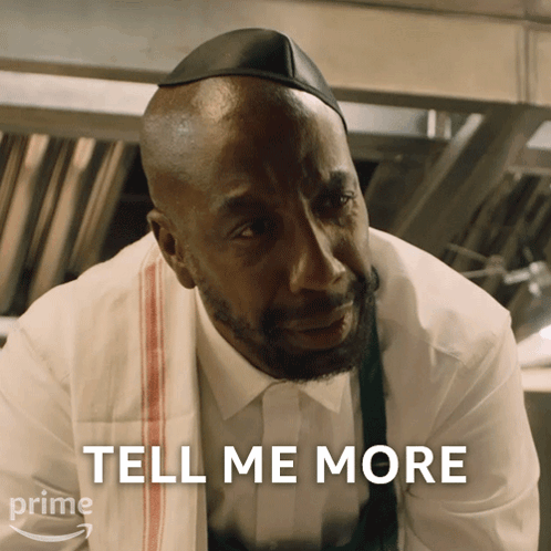 A Man With A Towel Around His Neck And The Words Tell Me More Above Him GIF