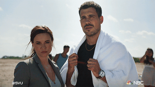 A Man With A Towel Around His Neck Stands Next To A Woman With #Svu On The Bottom GIF