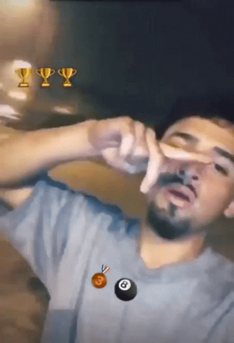 A Man With A Trophy And A Pool Ball In The Background GIF