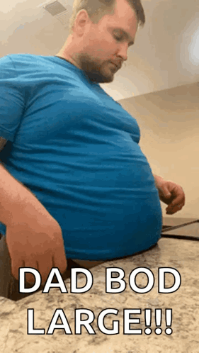 A Man With A Very Large Belly Is Sitting On A Counter And Says Dad Bod Large !! GIF