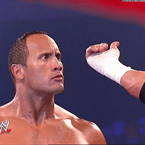 a man with a w logo on his chest is being punched in the face