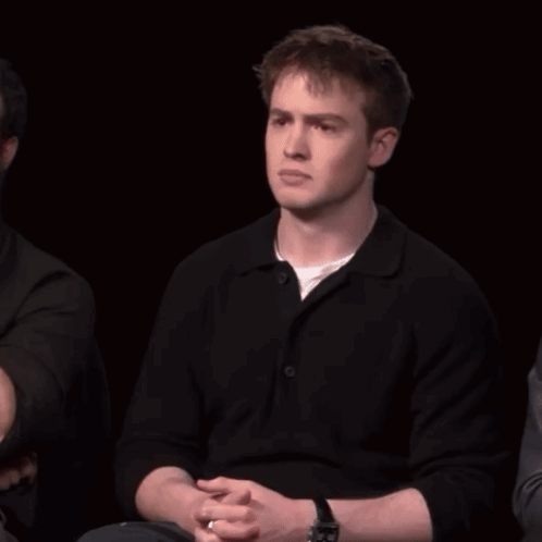 A Man With A Watch On His Wrist Is Laughing With His Mouth Open GIF