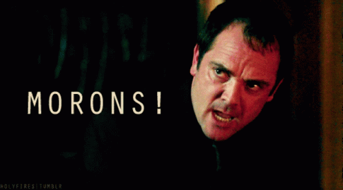 A Man With An Angry Look On His Face With The Words Morons Written Above Him GIF