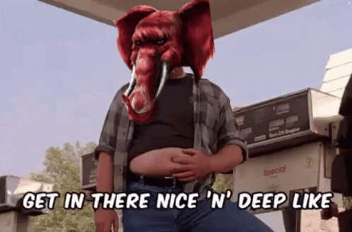A Man With An Elephant Mask On His Head Says Get In There Nice N ' Deep Like GIF
