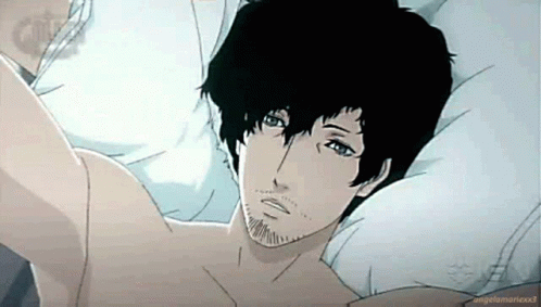 A Man With Black Hair And A Beard Is Laying In Bed . GIF
