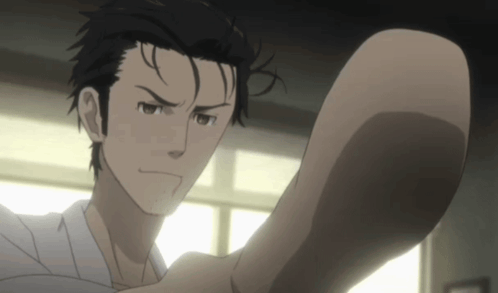 A Man With Black Hair And A White Shirt Is Looking At Something GIF