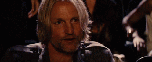 A Man With Blonde Hair And A Beard Is Holding A Bottle In His Hand GIF