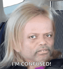 A Man With Blonde Hair And A Beard Is Sitting In A Car And Says I 'M Confused . GIF