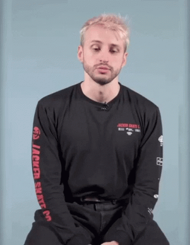 A Man With Blonde Hair And A Beard Is Wearing A Black Shirt With The Word Jackie On The Front . GIF
