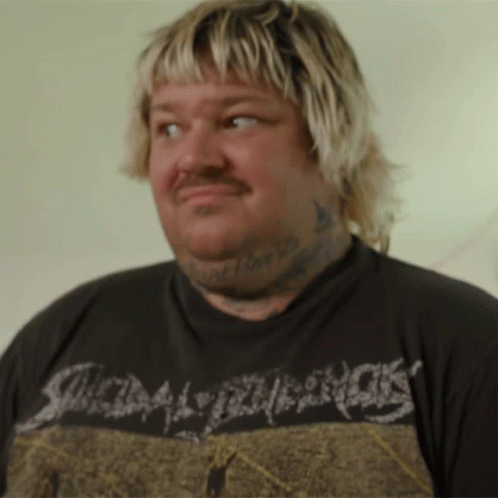 A Man With Blonde Hair And A Tattoo On His Neck Is Wearing A Shirt That Says Scum GIF