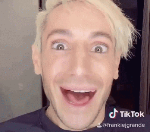 A Man With Blonde Hair Is Making A Funny Face . GIF