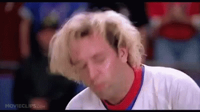 A Man With Blonde Hair Is Making A Funny Face While Wearing A White Shirt . GIF