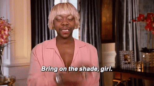 A Man With Blonde Hair Is Wearing A Pink Shirt And Saying `` Bring On The Shade Girl '' . GIF