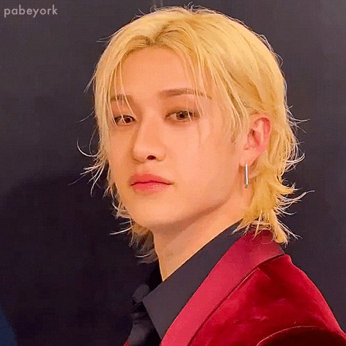 A Man With Blonde Hair Is Wearing A Red Jacket GIF