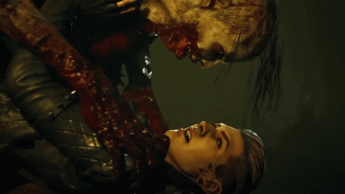 A Man With Blood Coming Out Of His Mouth Is Holding Another Man GIF