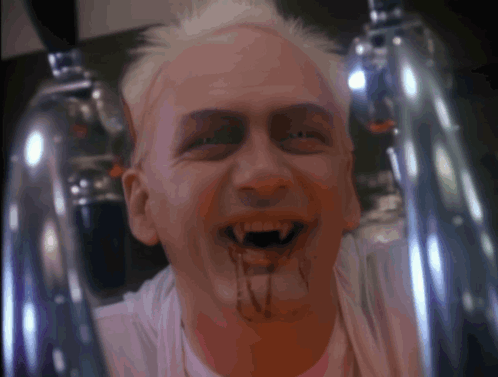 A Man With Blood Dripping From His Mouth And A White Shirt GIF