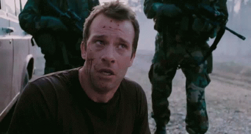 A Man With Blood On His Face Is Laying On The Ground In Front Of Soldiers GIF
