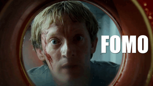 A Man With Blood On His Face Is Looking Through A Hole With The Word Fomo On It GIF