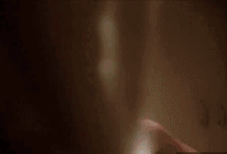 A Man With Blood On His Face Is Standing In A Locker Room . GIF
