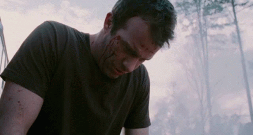A Man With Blood On His Face Is Wearing A Black T-Shirt GIF