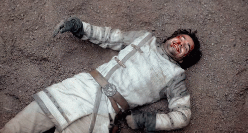 A Man With Blood On His Face Laying On The Ground GIF