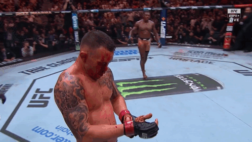 A Man With Blood On His Face Stands In A Ufc Boxing Ring GIF