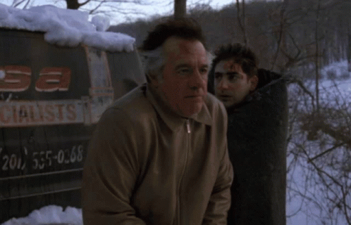 A Man With Blood On His Face Stands Next To Another Man In Front Of A Sign That Says " Sa Specialist " GIF