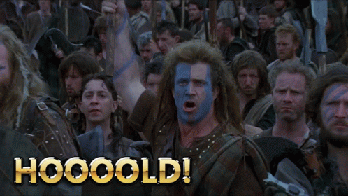 A Man With Blue And White Paint On His Face Stands In Front Of A Crowd With The Words Hooooold Written On The Bottom GIF