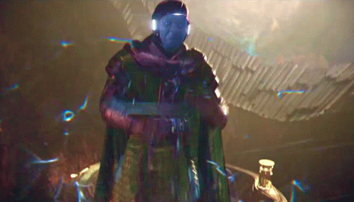 A Man With Blue Eyes And A Scarf Around His Neck Is Standing In A Dark Room GIF