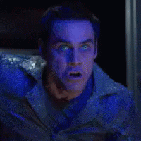 A Man With Blue Eyes Is Screaming With The Words Deal Behind Him GIF