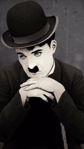 A Man With Blue Eyes Wearing A Bowler Hat And A Mustache GIF