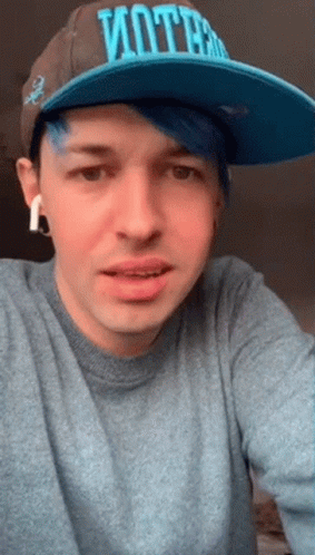 A Man With Blue Hair And A Hat That Says Vote GIF