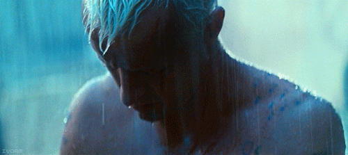 A Man With Blue Hair Is Taking A Shower In A Dark Room With A Watermark That Says Zuorin GIF