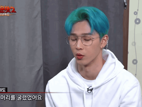 A Man With Blue Hair Wearing Glasses And A White Hoodie GIF