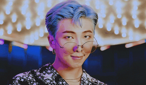 A Man With Blue Hair Wearing Glasses And Earrings GIF