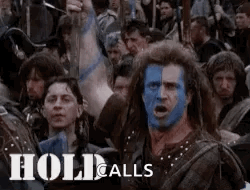 A Man With Blue Paint On His Face Is Surrounded By A Crowd Of People . GIF