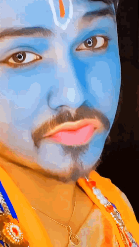 A Man With Blue Paint On His Face Is Wearing A Necklace . GIF