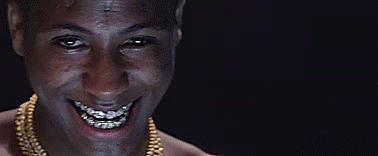 A Man With Braces On His Teeth Is Smiling And Wearing A Gold Chain . GIF