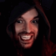 A Man With Braces On His Teeth Is Smiling In A Dark Room . GIF