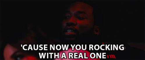 A Man With Braces On His Teeth Says " Cause Now You Rocking With A Real One " In A Dark Room GIF