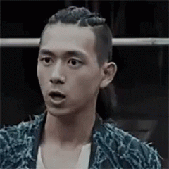 A Man With Braids On His Head Is Making A Surprised Face . GIF