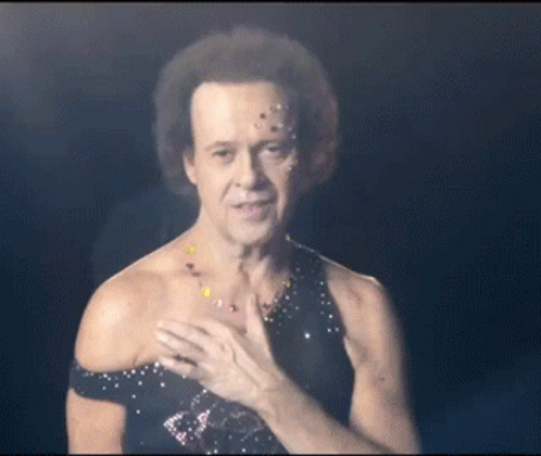A Man With Confetti On His Face Is Wearing A Black Top GIF