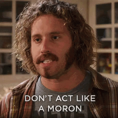 A Man With Curly Hair And A Beard Is Saying " Don 'T Act Like A Moron " GIF