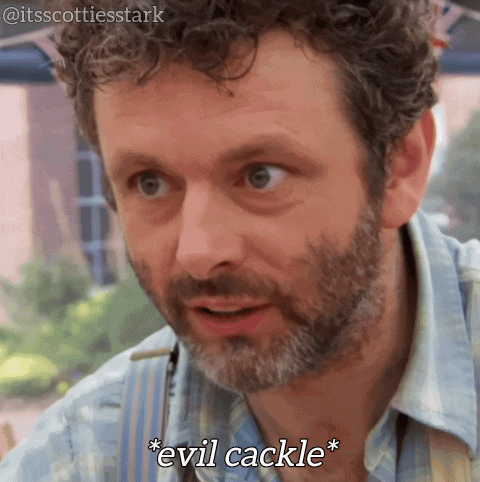 A Man With Curly Hair And A Beard Is Saying " Evil Cackle " GIF
