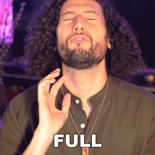 A Man With Curly Hair And A Beard Is Wearing A Necklace That Says Full GIF