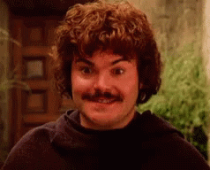 A Man With Curly Hair And A Mustache Is Smiling At The Camera . GIF